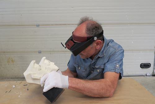 Gérard Haligon examinant à la loupe binoculaire la précision de restitution de la peau de surface
